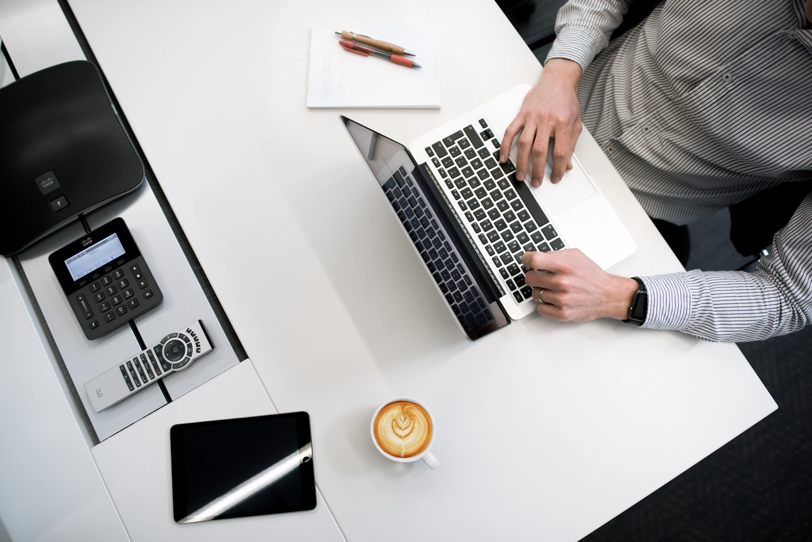 Desk with a telephone, laptop and documents in a professional office