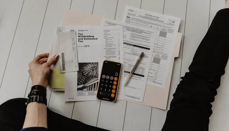 An accountant working at a desk with documents in a Dubai office
