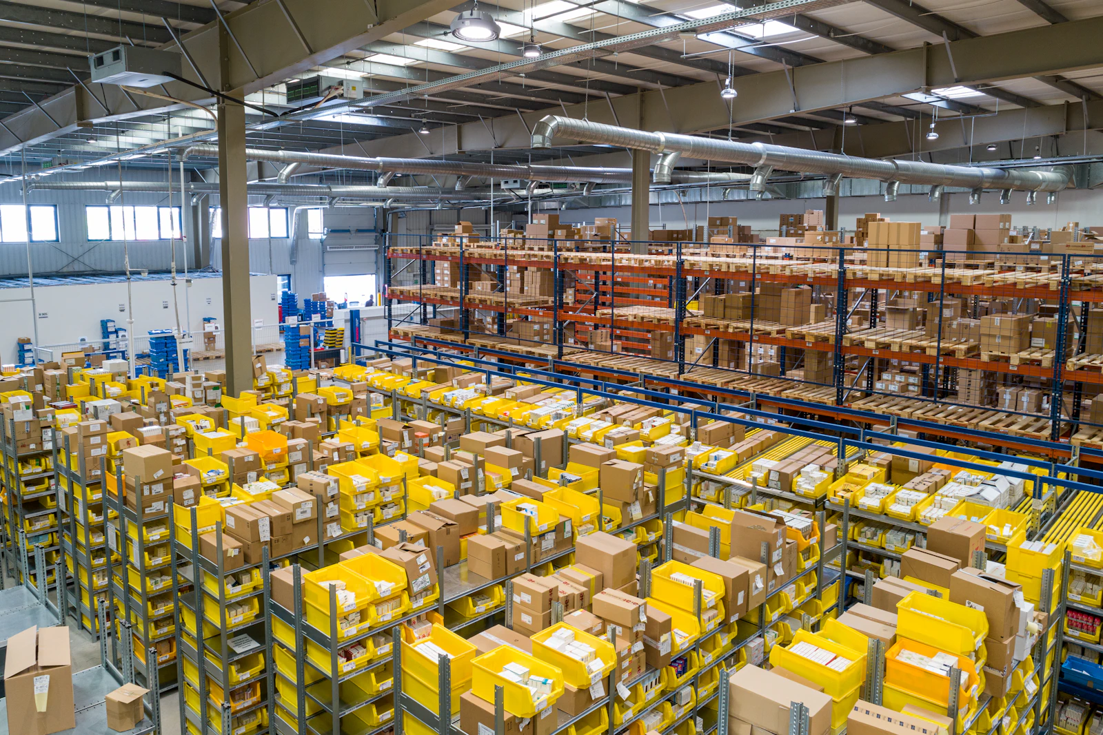 Delivery vans and a logistics worker with a handheld device in Dubai